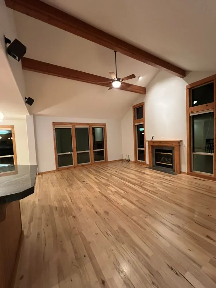 Living area with exposed beams by FED Builder