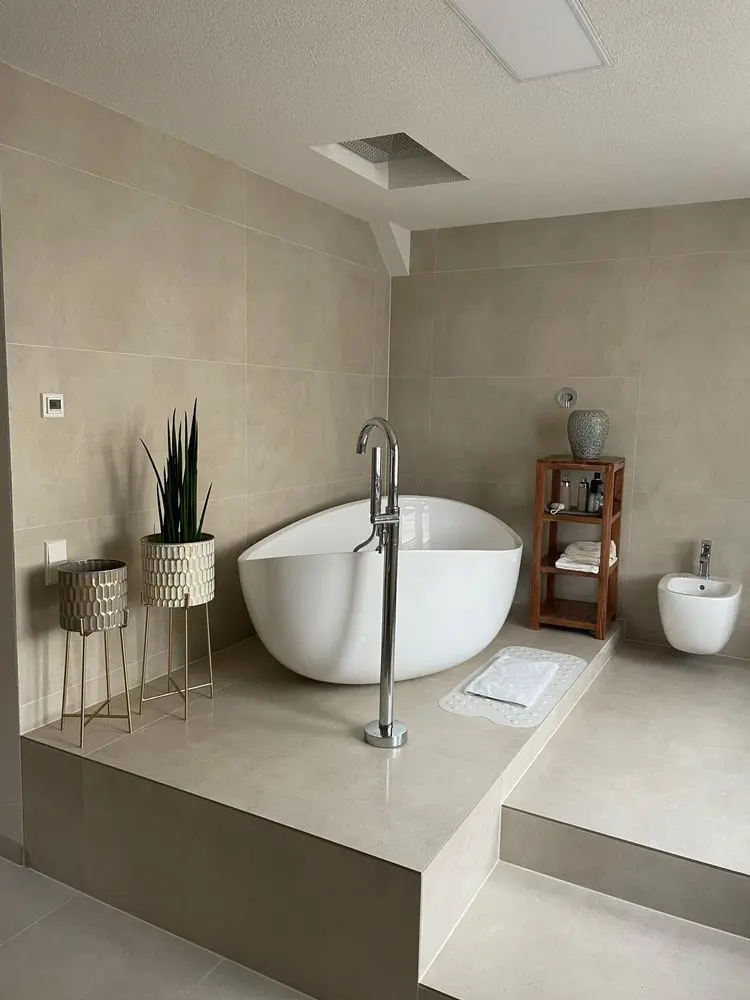Bathroom with freestanding tub by FED Builder